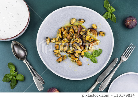 Fried seafood on a plate, mussels. 130179834