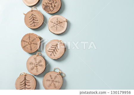 Christmas toy made of decorative wooden slice with ornament. Christmas toy made of decorative wooden slice with ornament. 130179956