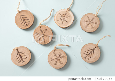 Christmas toy made of decorative wooden slice with ornament. Christmas toy made of decorative wooden slice with ornament. 130179957