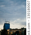 Krakow cityscape glowing at sunset, featuring modern buildings and striking skyscraper against backdrop of dramatic, cloudy sky, creating enchanting urban atmosphere. Modern architectural silhouettes  130180007