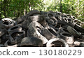 Abandoned tires are blending seamlessly into the forest background, raising significant environmental concerns 130180229