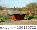 Burning Waste Materials in an Old Rusting Metal Rubbish Skip 130180722
