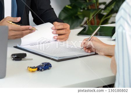 Insurance Consultation. Client discussing car insurance options with an agent. Insurance Consultation. Client discussing car insurance options with an agent. 130180802