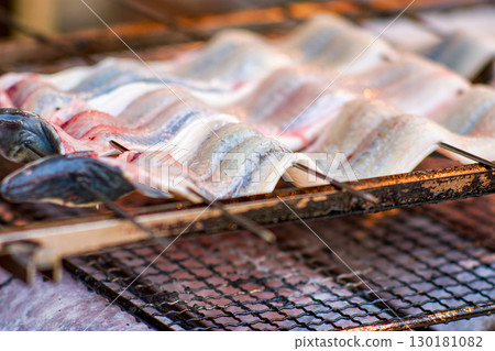 Grilled fish fillets skewers on a barbecue grill 130181082