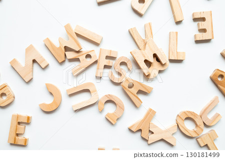 Scattered wooden alphabet letters on white background 130181499