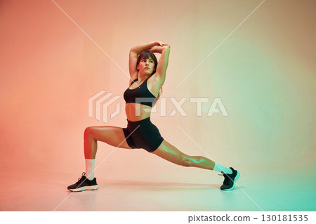 Yoga asana, for legs. Young woman in fitness clothes is in the studio Yoga asana, for legs. Young woman in fitness clothes is in the studio 130181535