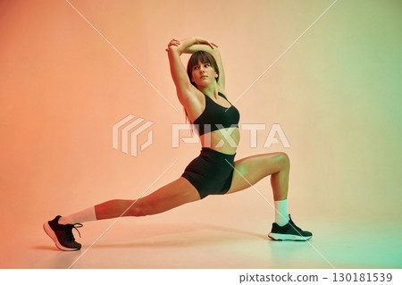 Yoga asana, for legs. Young woman in fitness clothes is in the studio 130181539