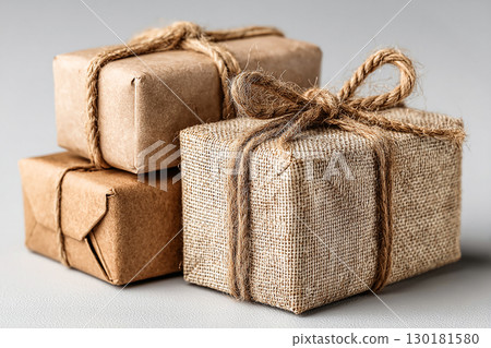 Classic gift. Minimalist brown Kraft Gift Box with twine bow on white background. 130181580