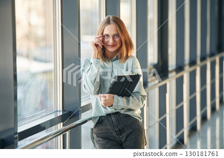 Front view. Young woman in airport hall Front view. Young woman in airport hall 130181761