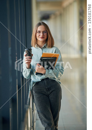 Positive young woman is in airport hall Positive young woman is in airport hall 130181768