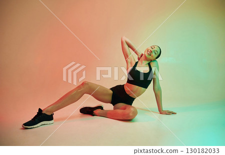 Skinny body shape. Young fitness woman in sportive clothes against background in studio Skinny body shape. Young fitness woman in sportive clothes against background in studio 130182033