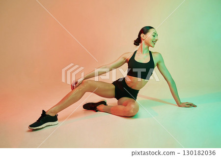Skinny body shape. Young fitness woman in sportive clothes against background in studio Skinny body shape. Young fitness woman in sportive clothes against background in studio 130182036