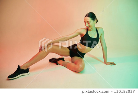 Skinny body shape. Young fitness woman in sportive clothes against background in studio 130182037