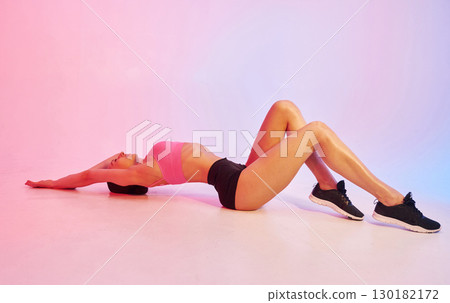 Side view. Young fitness woman in sportive clothes against background in studio Side view. Young fitness woman in sportive clothes against background in studio 130182172