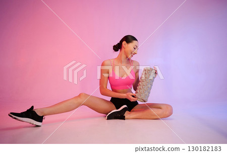Professional fitness woman in sportive clothes against background in studio Professional fitness woman in sportive clothes against background in studio 130182183