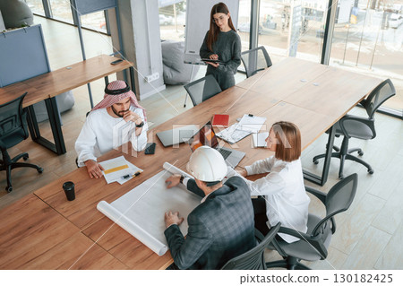 Financial problems task. Muslim businessman in traditional outfit with colleagues in office 130182425