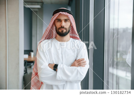 Successful Muslim businessman in traditional outfit in his office Successful Muslim businessman in traditional outfit in his office 130182734