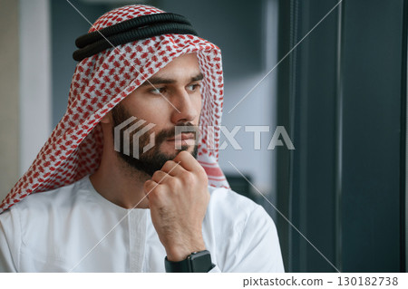 Close up portrait. Successful Muslim businessman in traditional outfit in his office Close up portrait. Successful Muslim businessman in traditional outfit in his office 130182738