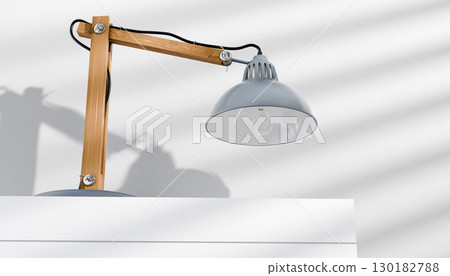 Retro or vintage style desk lamp, classic wooden arm with metal base and grey colored canopy, against white background, isolated. Retro or vintage style desk lamp, classic wooden arm with metal base and grey colored canopy, against white background, isolated. 130182788