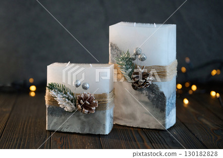 Festive garlands. Handmade beautiful decorative candles on the background Festive garlands. Handmade beautiful decorative candles on the background 130182828