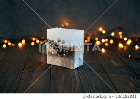 Festive garlands. Handmade beautiful decorative candle on the background 130182831