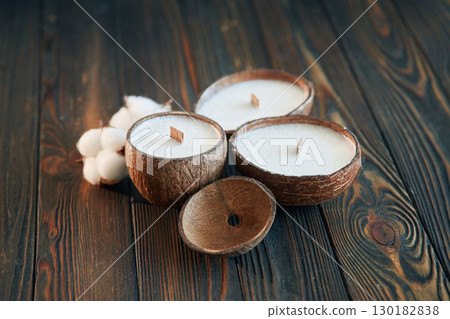 In shape of coconut. Handmade beautiful decorative candles on the background In shape of coconut. Handmade beautiful decorative candles on the background 130182838