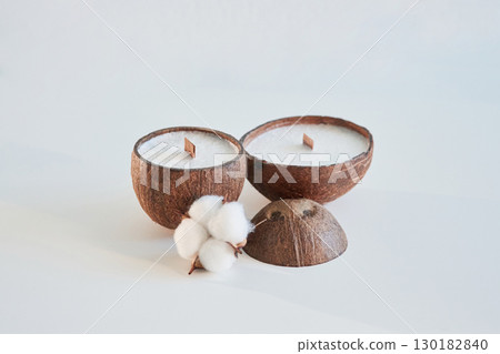Coconut shape. Handmade beautiful decorative candles on the background Coconut shape. Handmade beautiful decorative candles on the background 130182840