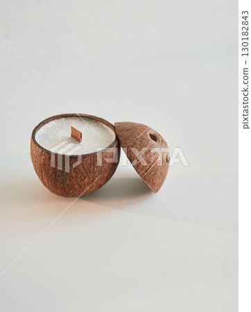 Coconut shape. Handmade beautiful decorative candles on the background Coconut shape. Handmade beautiful decorative candles on the background 130182843