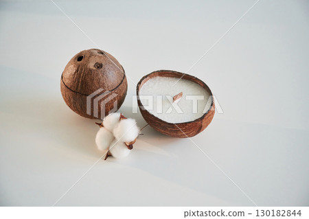 Coconut shape. Handmade beautiful decorative candles on the background 130182844