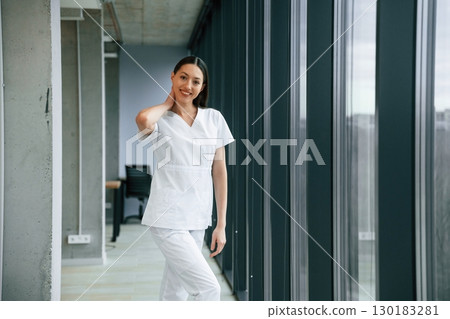 In the hall. Female doctor in white coat is indoors 130183281