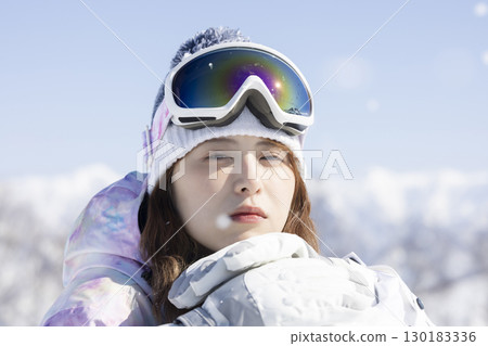 Cute woman enjoying the snow 130183336