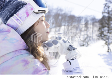 Cute woman enjoying the snowy mountains 130183450