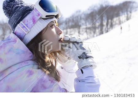 Cute woman enjoying the snowy mountains 130183453