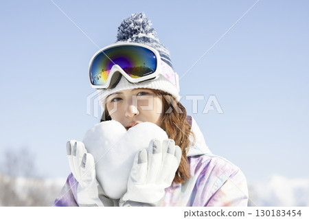 Cute woman enjoying the snowy mountains 130183454