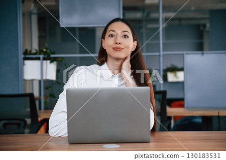 Working by using laptop. Businesswoman is indoors in the office 130183531