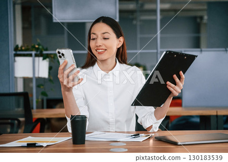 Businesswoman is indoors in the office 130183539