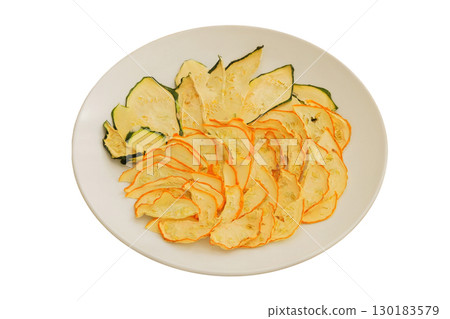 Survival food. Food prep Dried zucchini on a ceramic plate isolated on a white background. Various dry of zucchini. Survival food. Food prep Dried zucchini on a ceramic plate isolated on a white background. Various dry of zucchini. 130183579