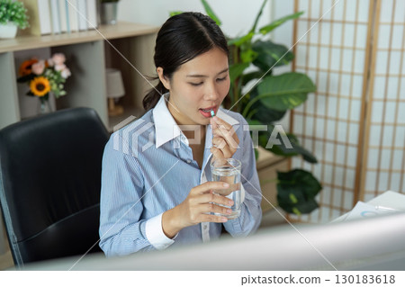 Office Syndrome Woman Drinking Water While Taking Medication Office Syndrome Woman Drinking Water While Taking Medication 130183618
