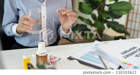 Office Syndrome Woman Preparing to Take Medication at Work 130183621