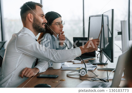 Conception of teamwork. Two employees are in the office together 130183773