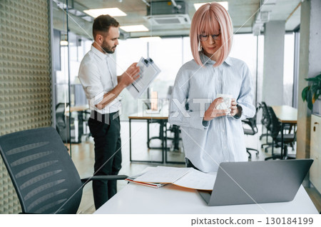 Dealing with documents. Man and woman are working in the office together 130184199