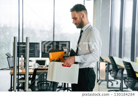 Unemployed man is with personal belongings after being fired 130184284