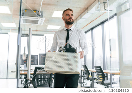 Front view. Unemployed man is with personal belongings after being fired Front view. Unemployed man is with personal belongings after being fired 130184310