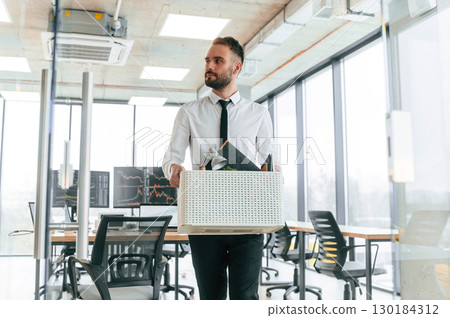 Front view. Unemployed man is with personal belongings after being fired 130184312