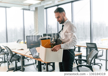 With box in hands. Unemployed man is with personal belongings after being fired 130184319