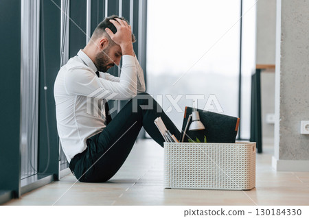 Unemployed man is with personal belongings after being fired 130184330