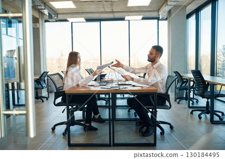 Working together. Man and woman employees are in the office 130184495
