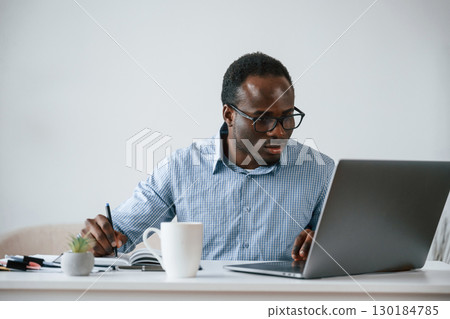 Manager is using laptop. Businessman is working in the office 130184785