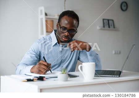 Manager is using laptop. Businessman is working in the office 130184786