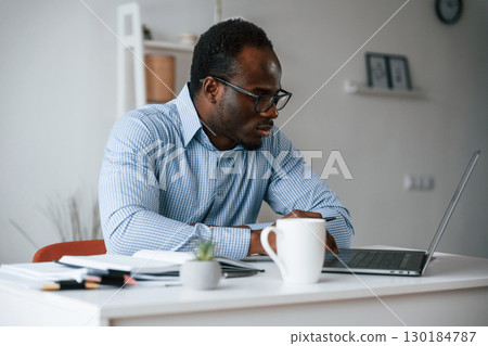 Manager is using laptop. Businessman is working in the office 130184787